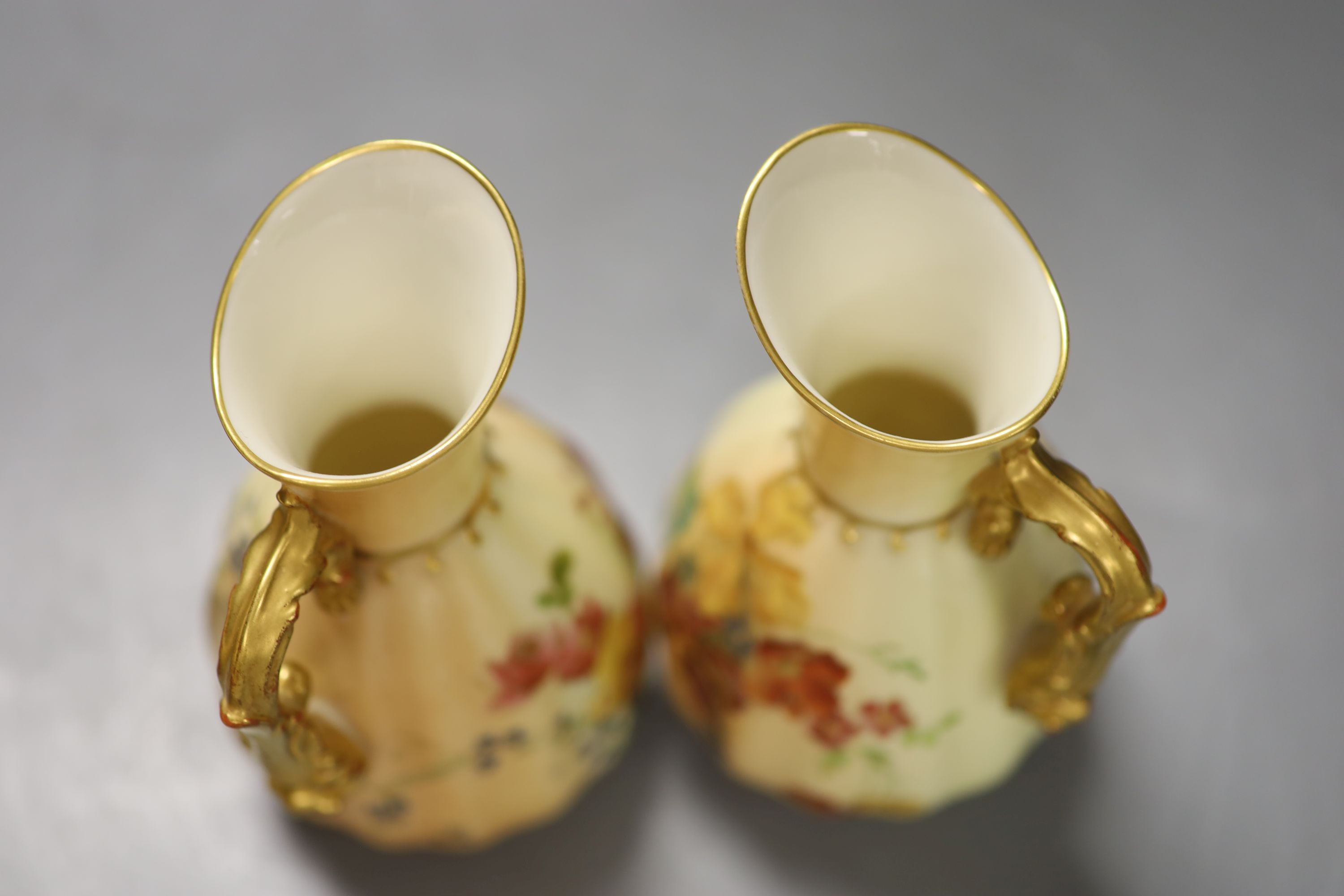 A Royal Worcester two-handled blush ivory vase, decorated with flowers, height 38cm, and a pair of similar jugs